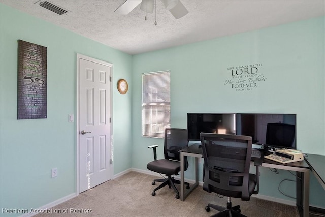 office featuring light carpet, a textured ceiling, and ceiling fan