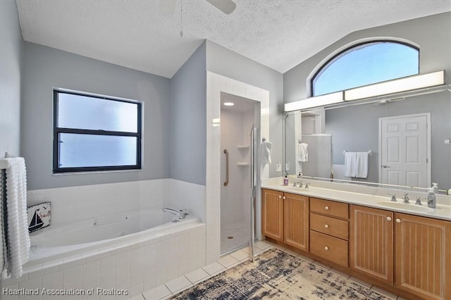 bathroom with vanity, a textured ceiling, separate shower and tub, tile patterned flooring, and lofted ceiling