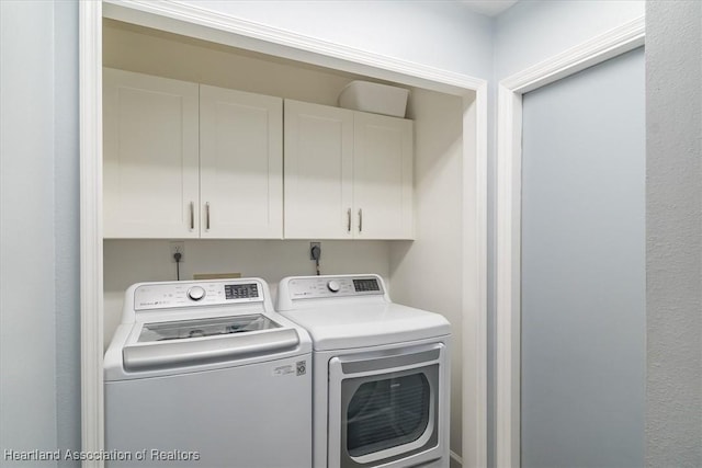 laundry area with cabinets and separate washer and dryer