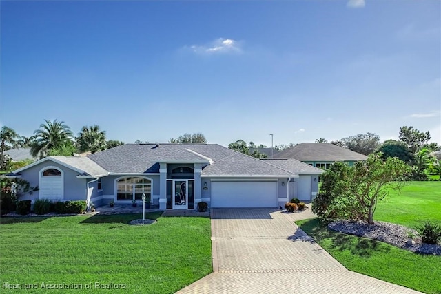 ranch-style home with a garage and a front lawn