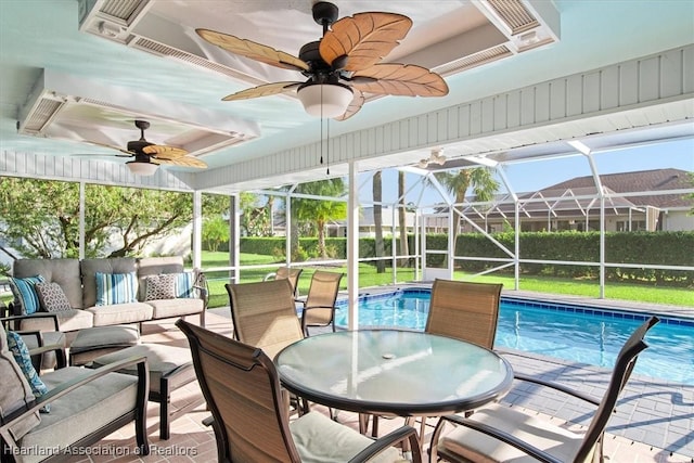 exterior space featuring an outdoor hangout area, glass enclosure, and a patio area