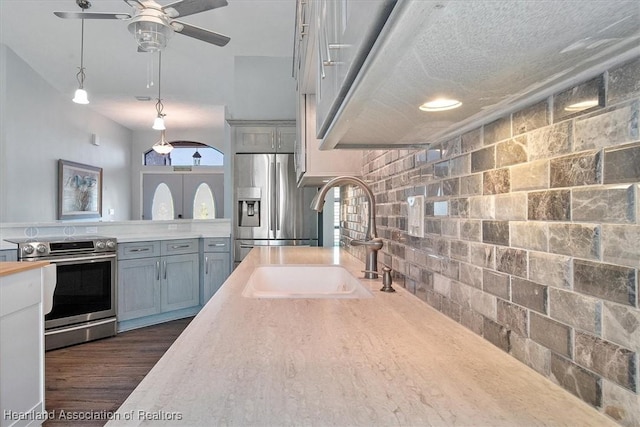 kitchen featuring gray cabinetry, sink, appliances with stainless steel finishes, and dark wood-type flooring