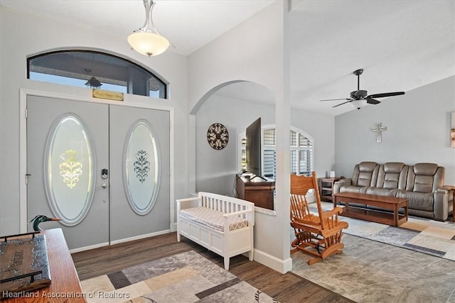 entrance foyer with ceiling fan, dark wood-type flooring, and lofted ceiling