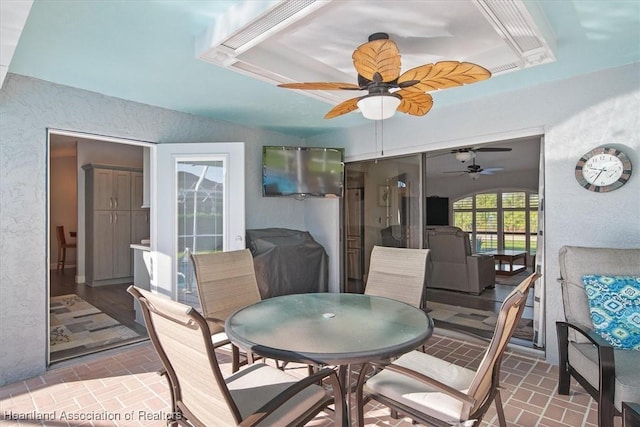 dining room featuring a raised ceiling and ceiling fan