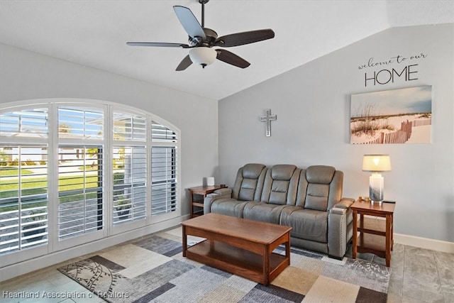 living room featuring ceiling fan and vaulted ceiling