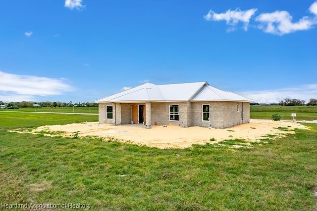 back of property featuring a lawn