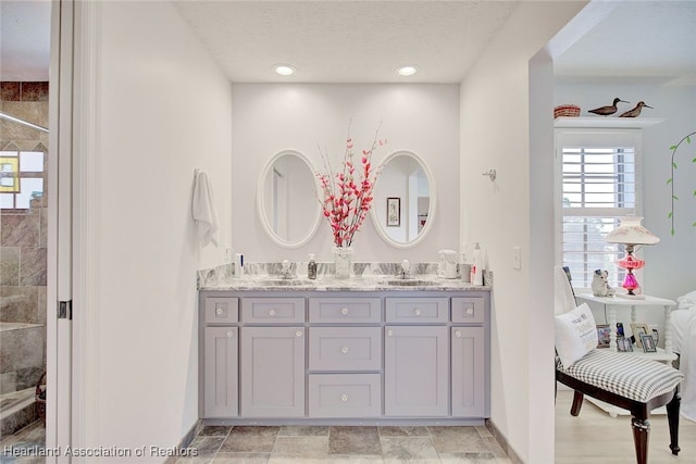 bathroom with vanity and a textured ceiling