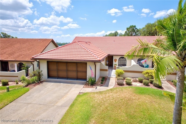 view of front of property with a front yard and a garage