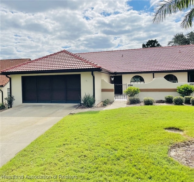 view of front of house featuring a garage and a front lawn