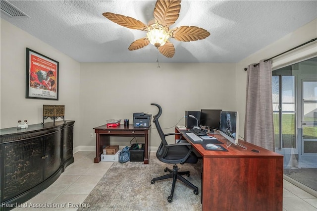 office area featuring ceiling fan, light tile patterned floors, and a textured ceiling