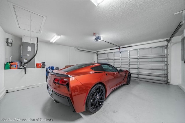 garage featuring heating unit and a garage door opener