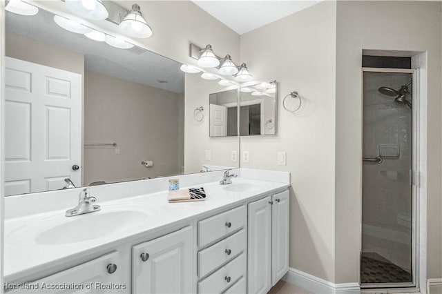 bathroom featuring vanity and a shower with shower door