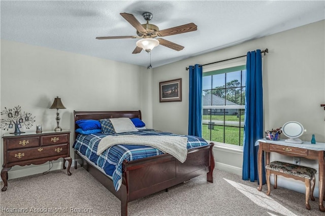 bedroom featuring carpet, a textured ceiling, and ceiling fan