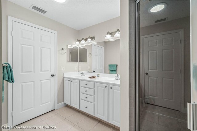 bathroom featuring tile patterned flooring and vanity