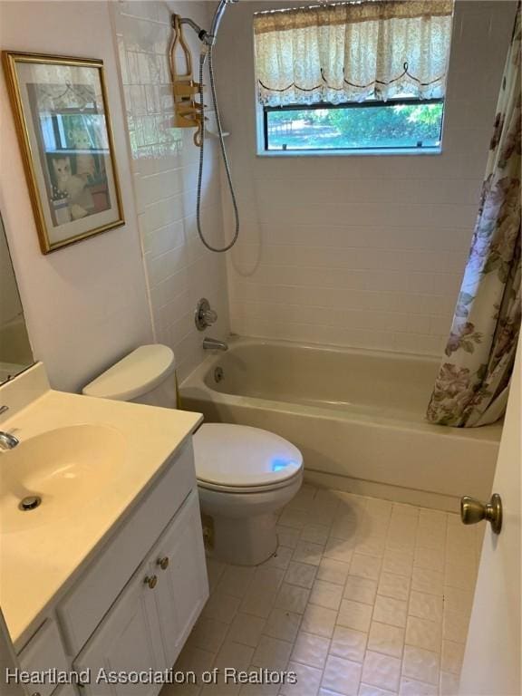 full bathroom with shower / bath combo with shower curtain, tile patterned floors, a healthy amount of sunlight, and toilet