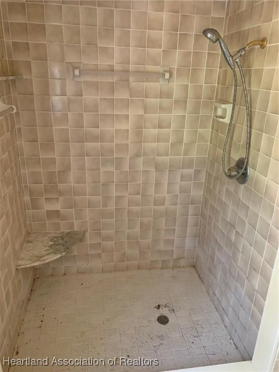 bathroom with tiled shower