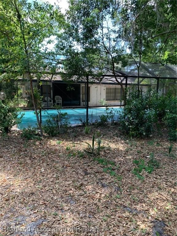 view of yard with a lanai and an outdoor pool