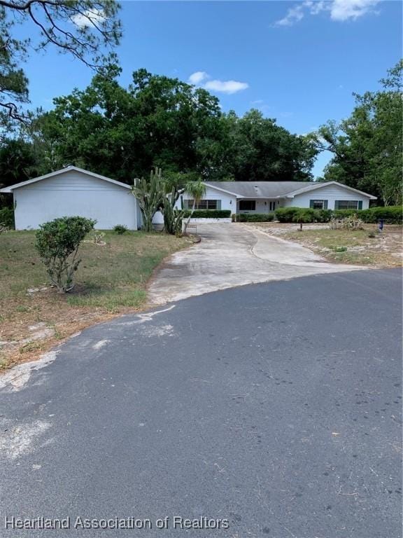 single story home featuring aphalt driveway