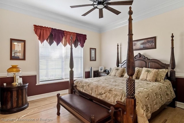 bedroom featuring light wood-type flooring, ceiling fan, and crown molding