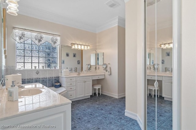 bathroom featuring vanity and ornamental molding