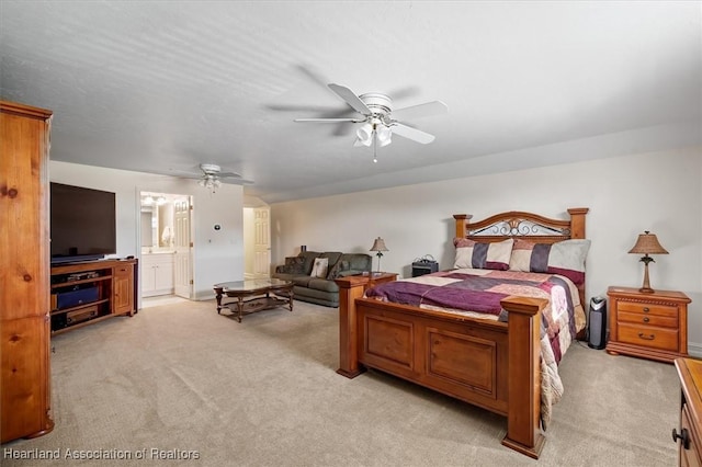 carpeted bedroom featuring ensuite bath and ceiling fan