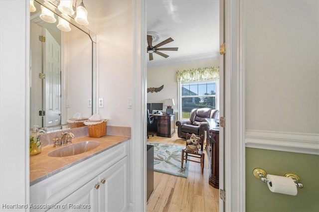 bathroom featuring vanity, crown molding, ceiling fan, and hardwood / wood-style flooring