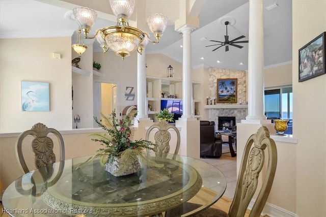 dining area featuring built in shelves, ornate columns, crown molding, vaulted ceiling, and ceiling fan with notable chandelier