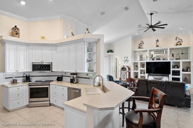 kitchen featuring kitchen peninsula, sink, white cabinets, and stainless steel appliances