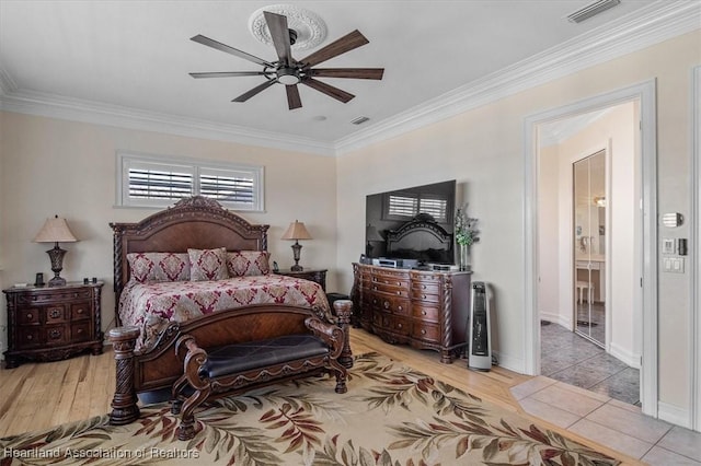 bedroom with ceiling fan, light tile patterned flooring, ensuite bathroom, and ornamental molding