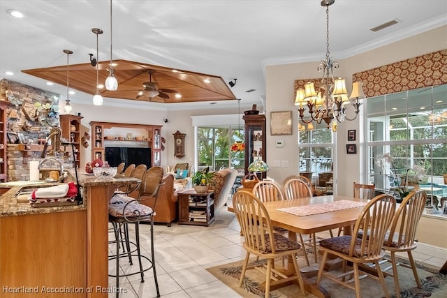 tiled dining room with wood ceiling, ceiling fan with notable chandelier, and ornamental molding