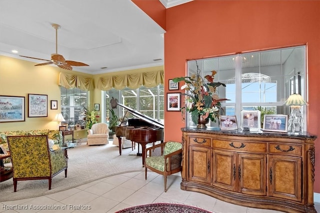 interior space featuring crown molding, ceiling fan, and light colored carpet