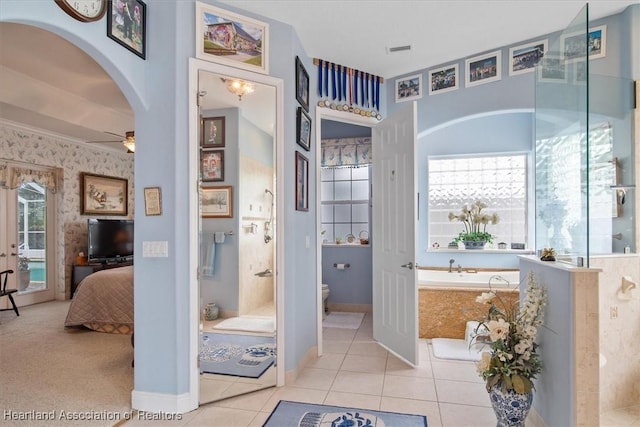 bathroom with ceiling fan, tile patterned flooring, and toilet