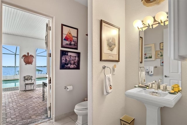 bathroom with a water view, toilet, and sink