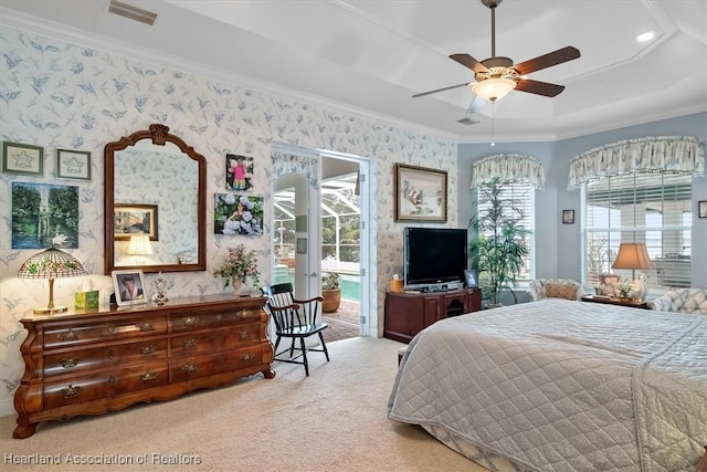 carpeted bedroom with access to outside, a raised ceiling, ceiling fan, and ornamental molding