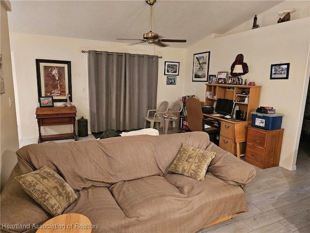 living room featuring ceiling fan and lofted ceiling