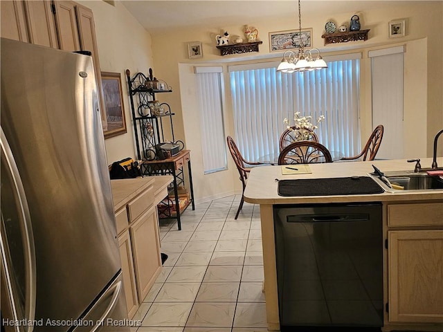 kitchen featuring pendant lighting, sink, stainless steel refrigerator, an inviting chandelier, and black dishwasher