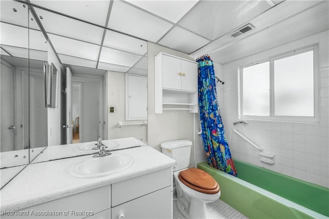 full bathroom with vanity, shower / tub combo, a paneled ceiling, and toilet