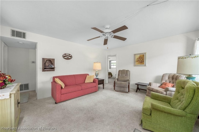 carpeted living room featuring ceiling fan