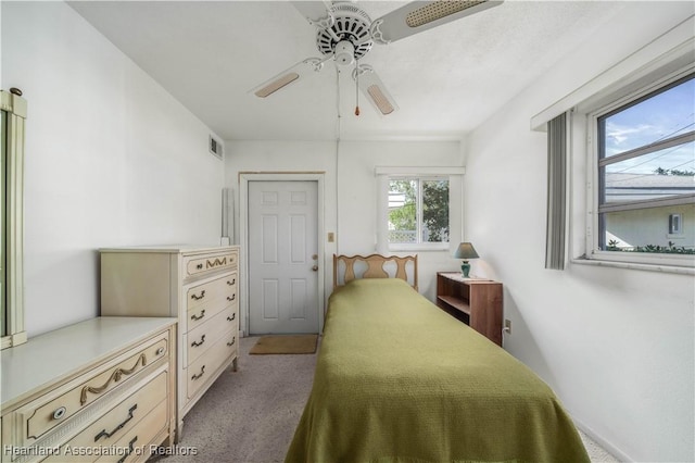 carpeted bedroom featuring ceiling fan