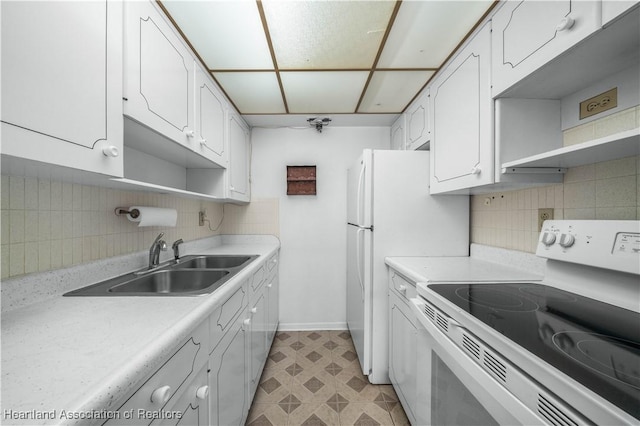 kitchen with range with electric stovetop, backsplash, sink, and white cabinets