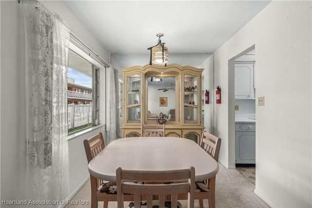 dining area featuring light colored carpet