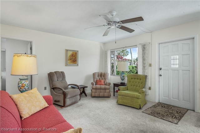 carpeted living room with ceiling fan