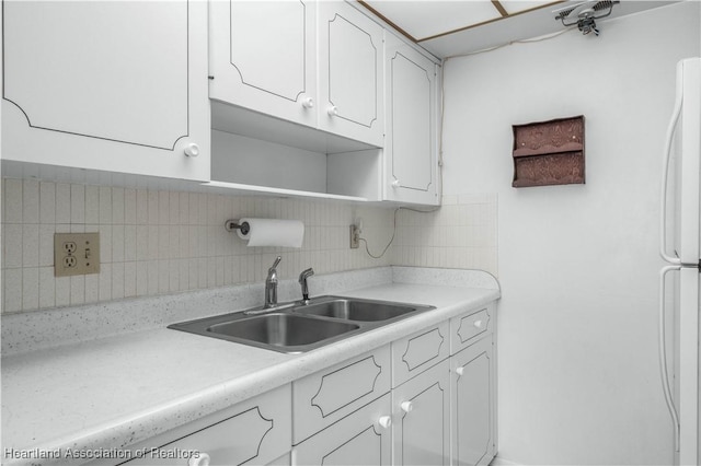 2113 Lakeview Dr Unit 1B, Sebring, FL 33870 - kitchen featuring white cabinets, light countertops, and tasteful backsplash