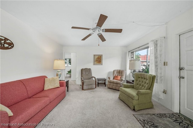 living room featuring light colored carpet and ceiling fan