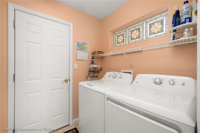 clothes washing area with laundry area, washer and clothes dryer, and baseboards