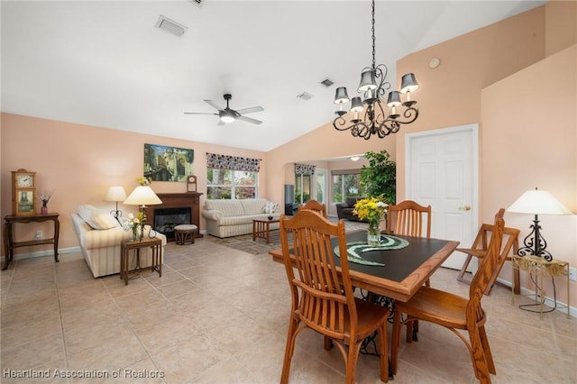 dining space with light tile patterned floors, baseboards, ceiling fan with notable chandelier, and visible vents