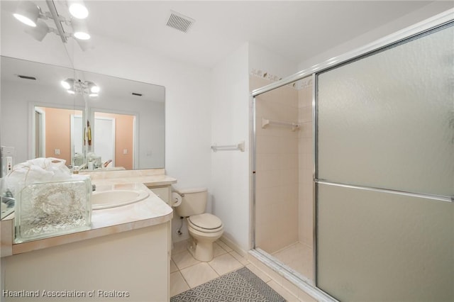 full bathroom featuring visible vents, a stall shower, vanity, tile patterned floors, and toilet