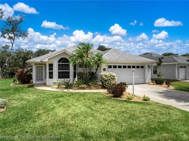 ranch-style home with an attached garage, driveway, and a front yard