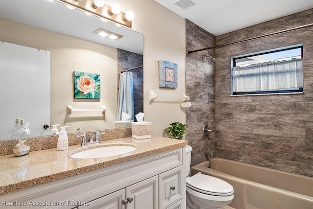 full bathroom featuring vanity, toilet, and shower / bath combination with curtain