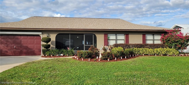 single story home featuring a garage and a front yard